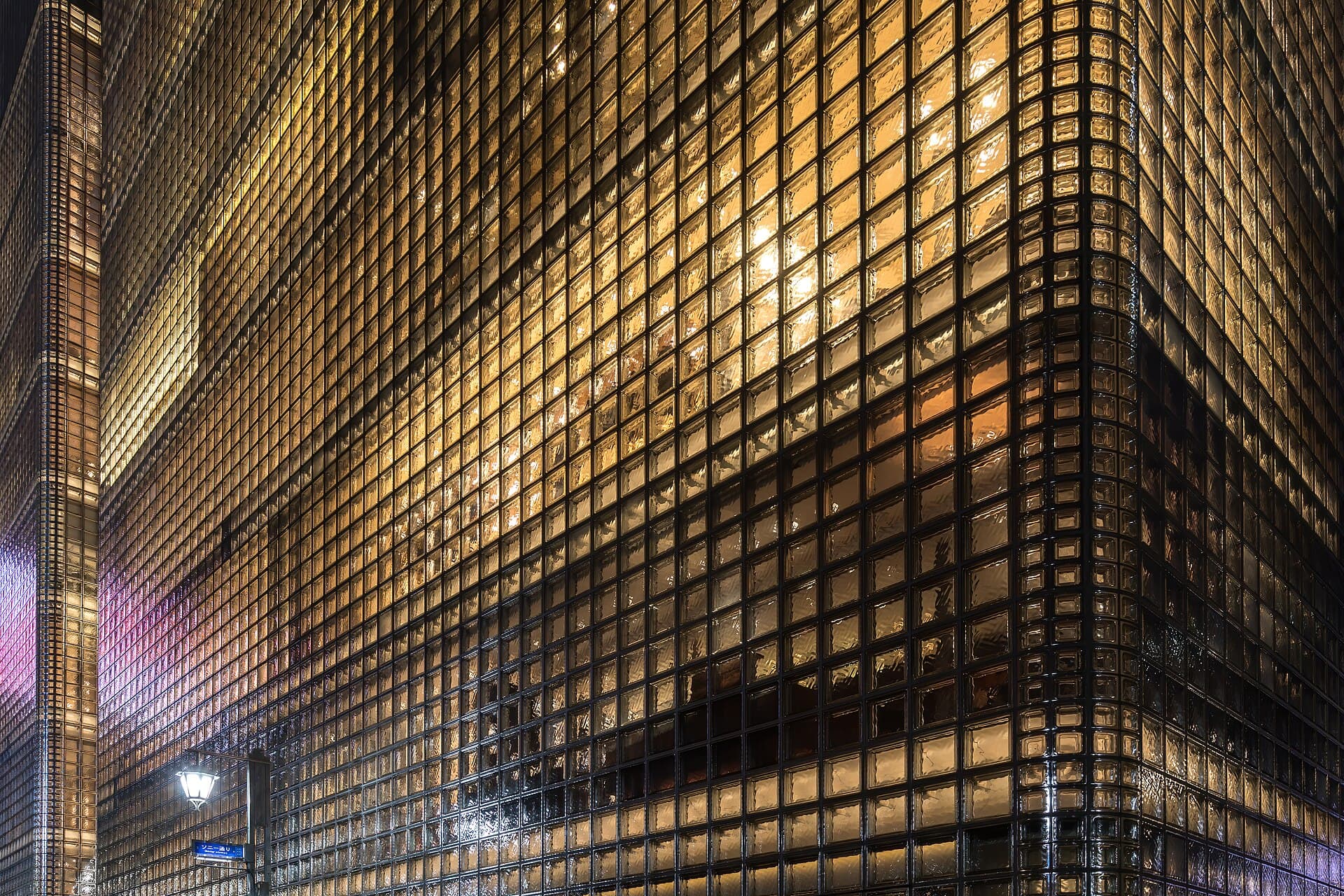 Exterior view of the illuminated facade of the building Maison Hermès made of glass blocks, and located at 5-4-1 Ginza, Chuo-ku , Tokyo , Japan . Constructed between 1998 and 2001, it was designed by…